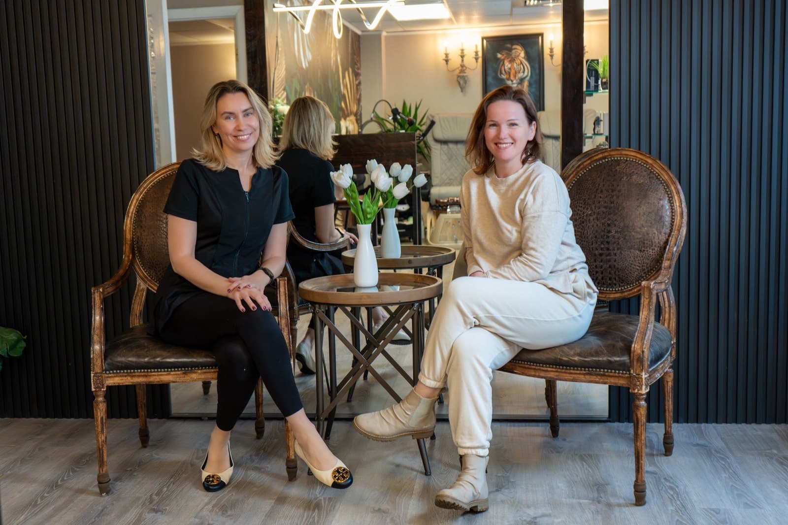 Two members of the LNO Boutique team seated in the lounge in Centennial, Colorado
