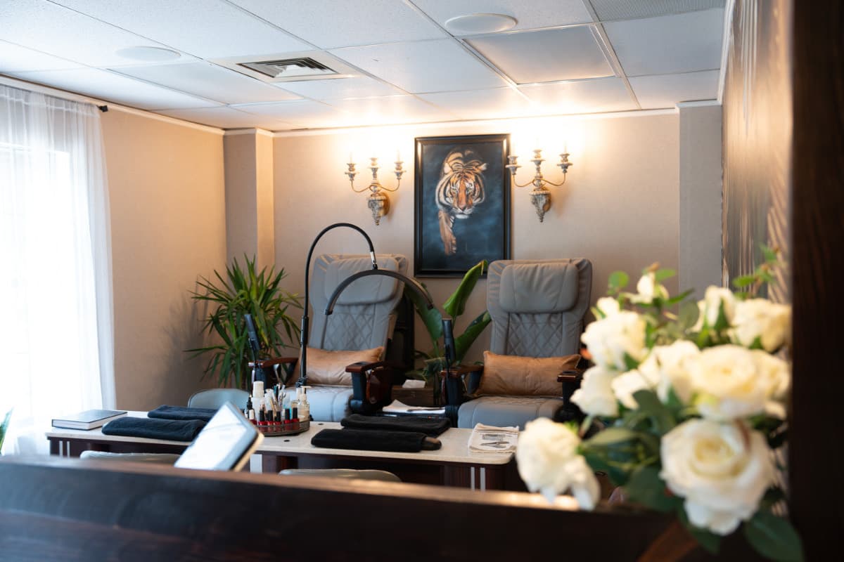 Elegant manicure station beneath the painted monstera wall at LNO Boutique nail salon in Centennial near Denver