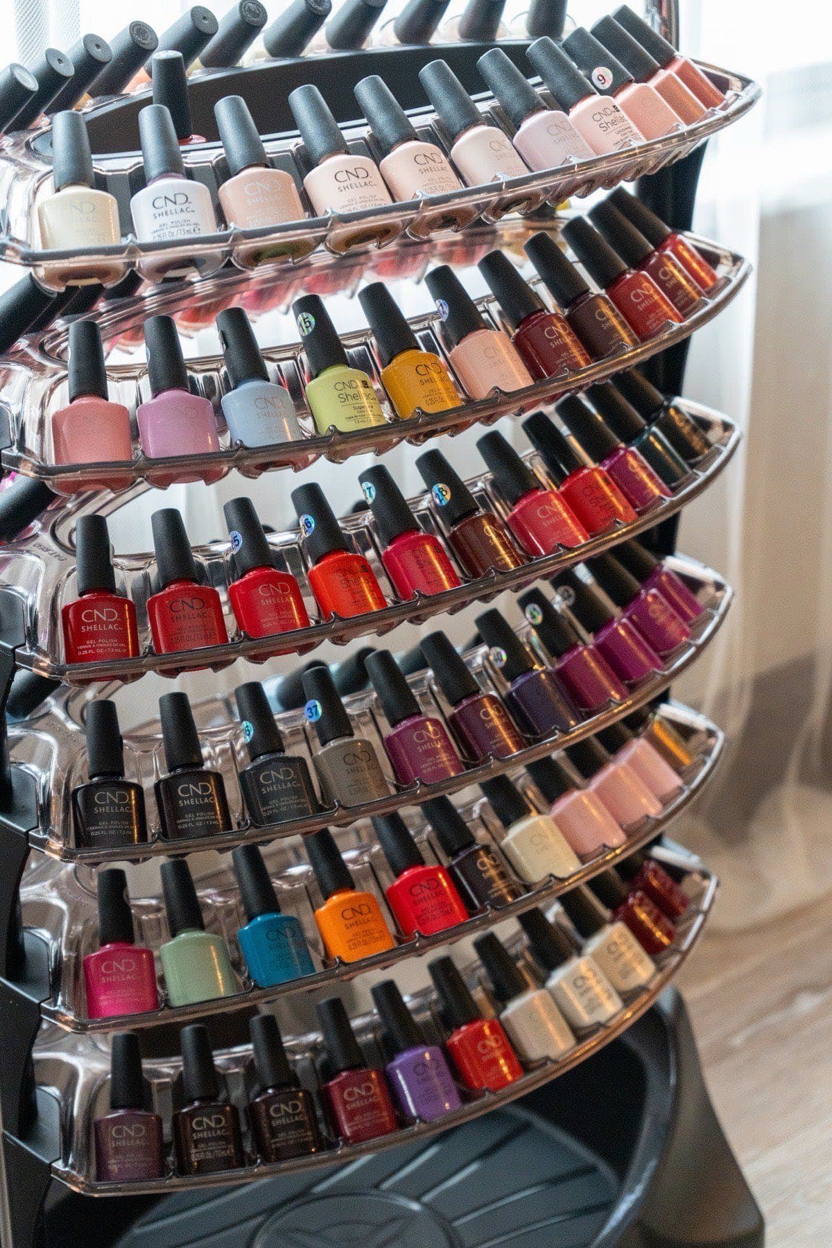 Rack of gel and lacquer polish colours at LNO Boutique nail salon in Centennial, CO