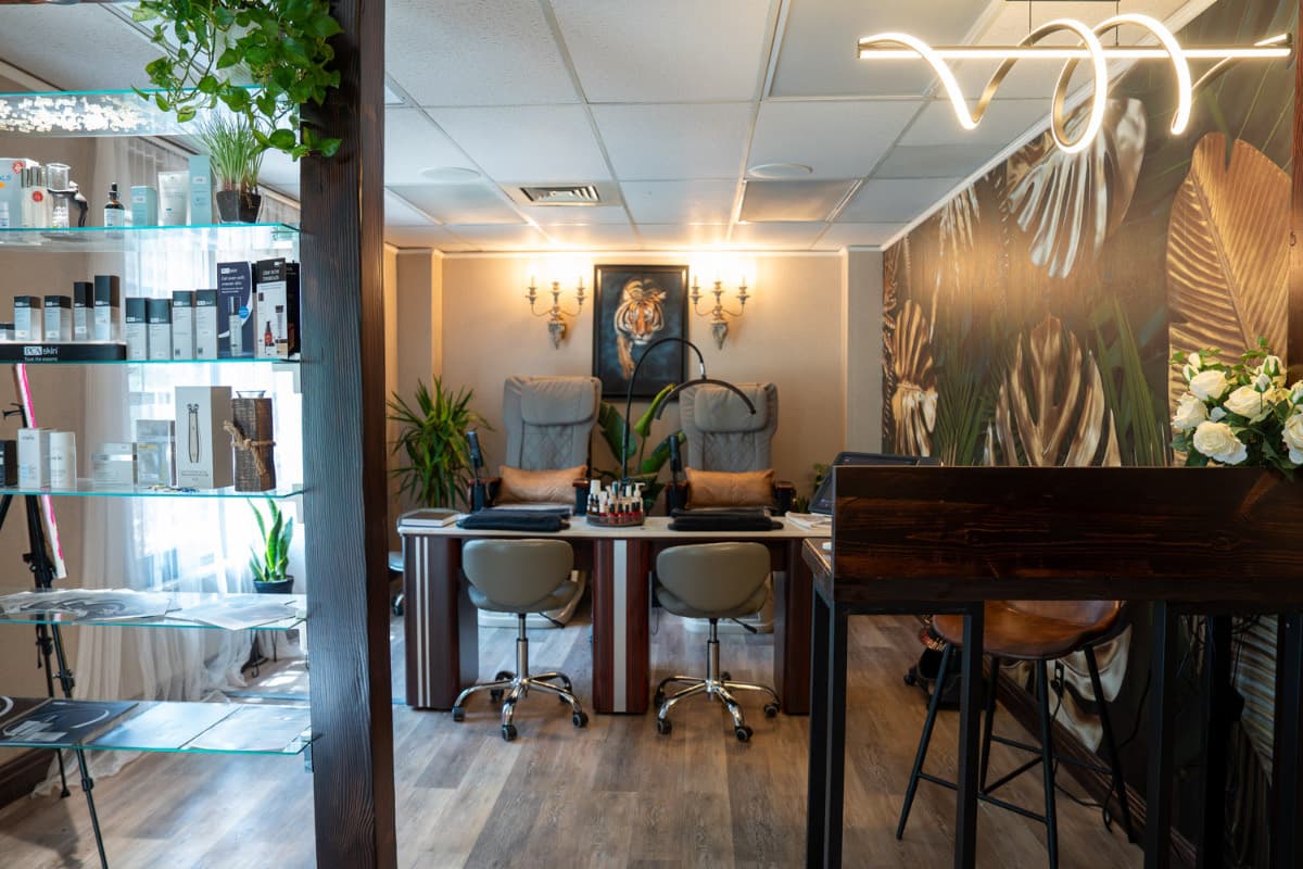 Nail salon and med spa interior with sconces and the monstera wall at LNO Boutique in Centennial, Colorado
