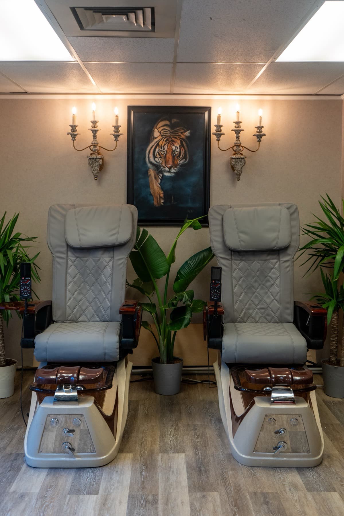 Two pedicure chairs side by side beneath tiger paintings at LNO Boutique in Centennial, Colorado