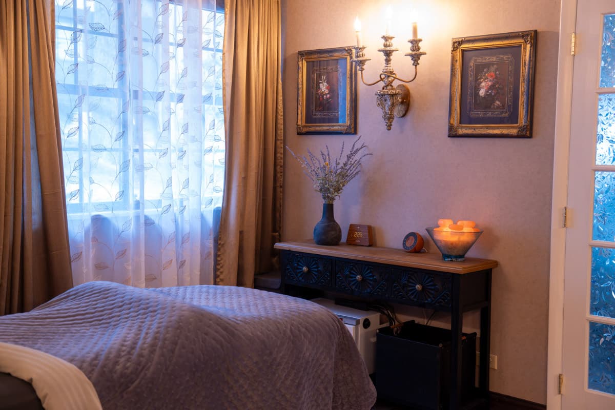 Private candle-lit massage therapy room at LNO Boutique day spa serving Centennial and Denver
