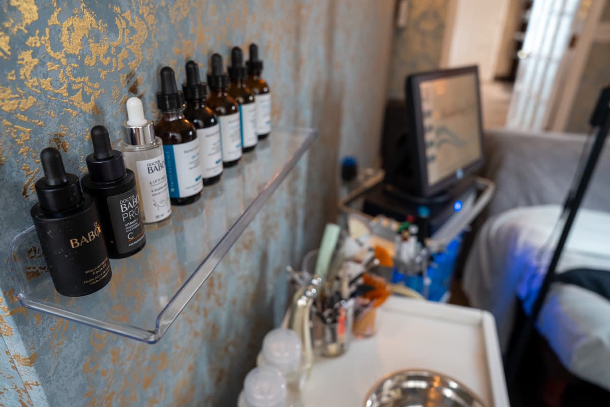 Wall of professional skincare serums and oils used in facials at LNO Boutique med spa in Centennial