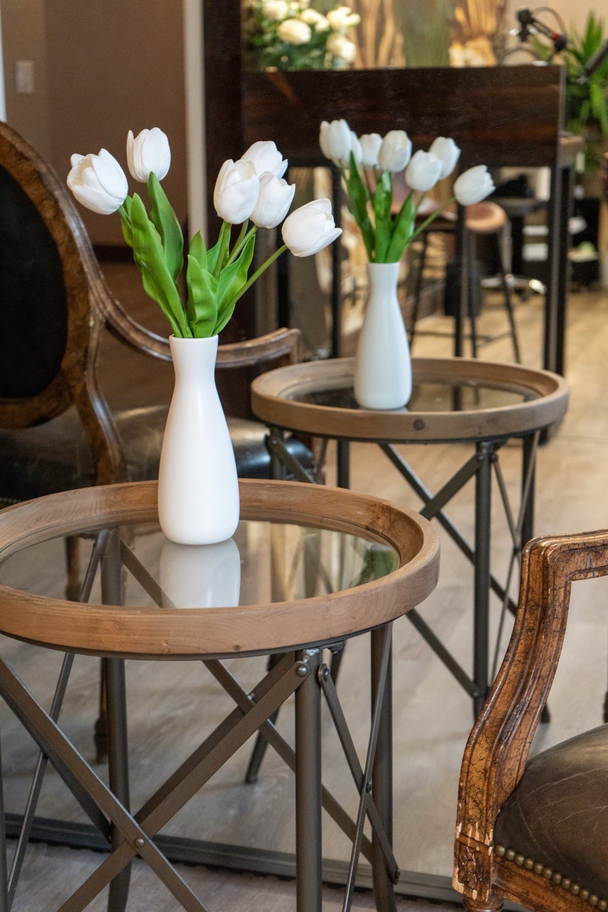 White tulips in vases on the side tables of the lounge at LNO Boutique in Centennial