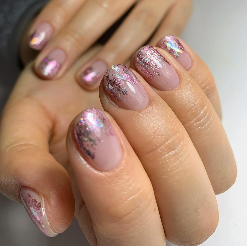 a close up of a hand with painted nails